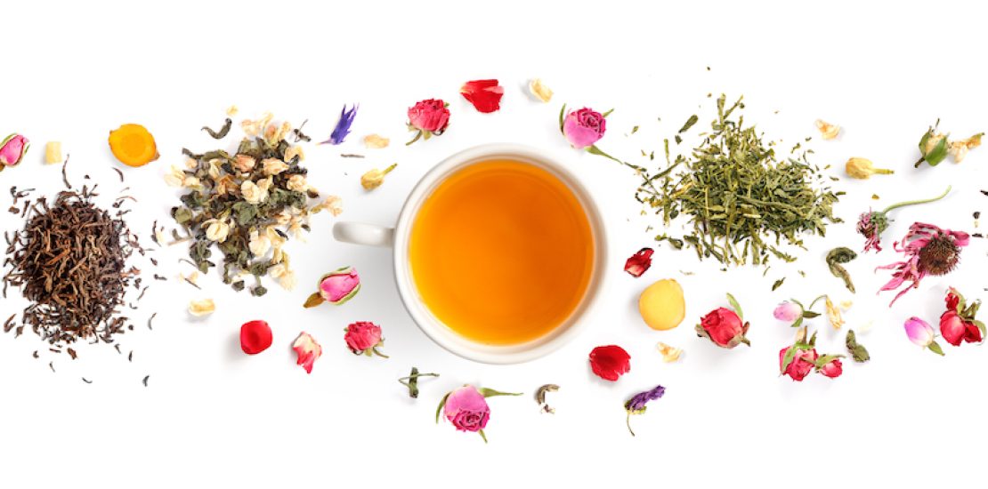 Creative layout made of cup of tea, green tea, black tea, fruit and herbal, tea, turmeric, ginger on white background.Flat lay. Food concept.